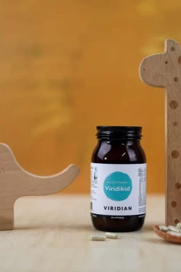 viridikid multivitamin jar with wooden toys and a spoonful of capsules