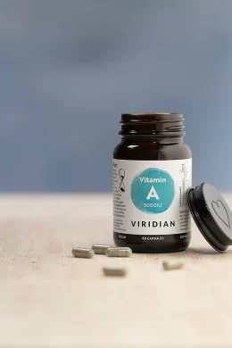 vitamin-a 5000iu jar in natural lighting with some capsules on the table